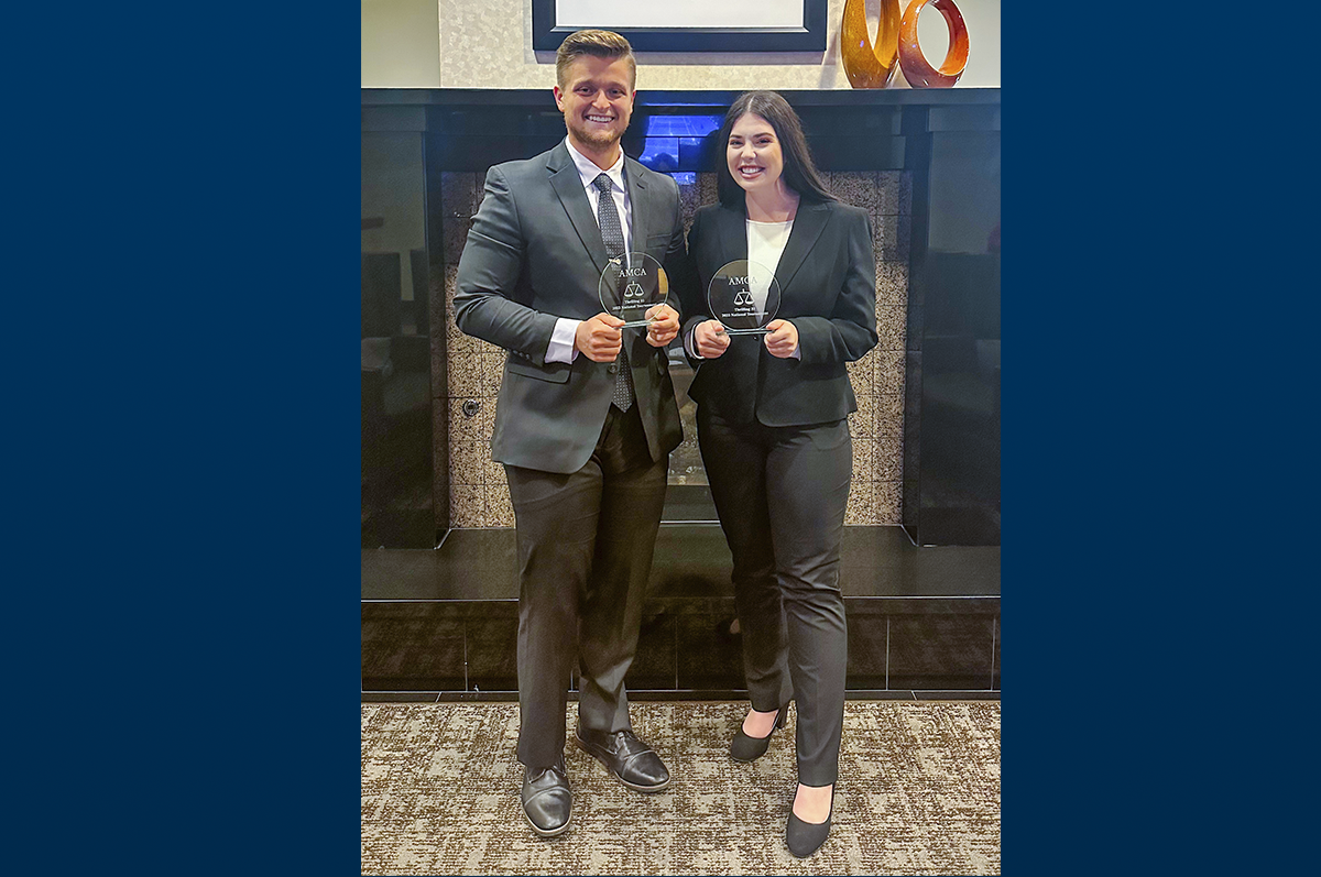 male and female students holding awards